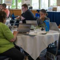 quiet time of persons working independently at a table indoors